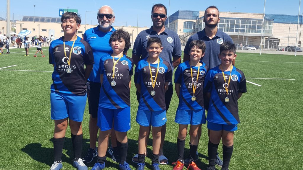 Jóvenes jugadores con medallas junto a sus entrenadores